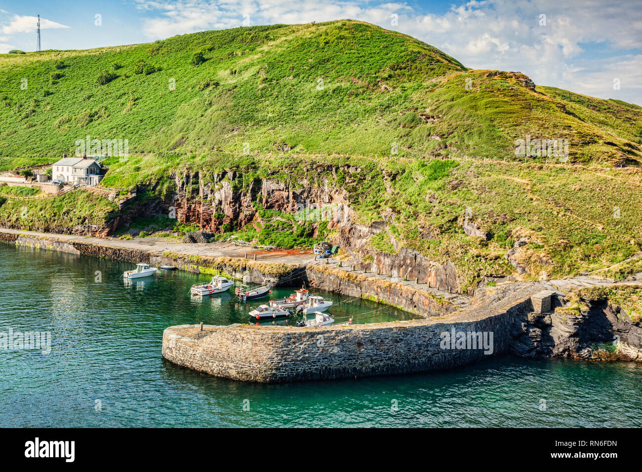 Boscastle Harbour, with its breakwater, boats and village houses. Stock Photo