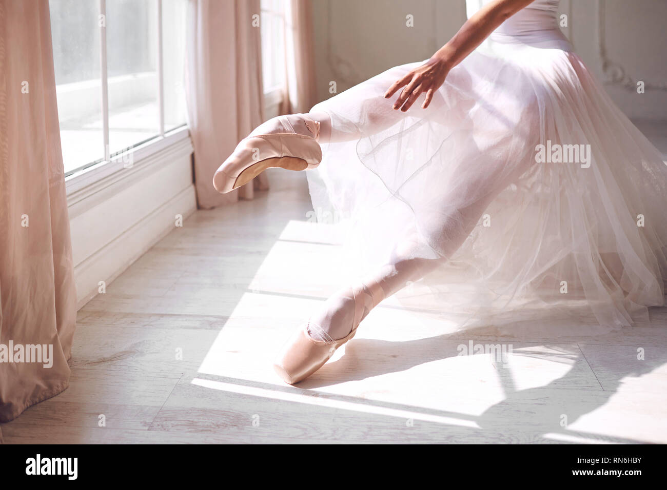 Pointe shoes on the feet of a ballerina. Stock Photo
