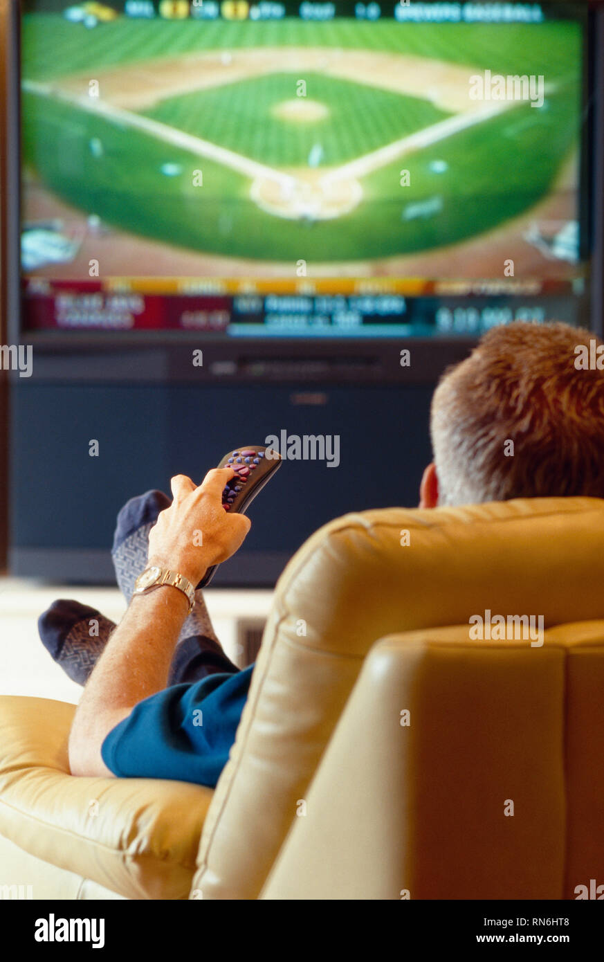 Mature man watching a baseball game on TV, USA Stock Photo