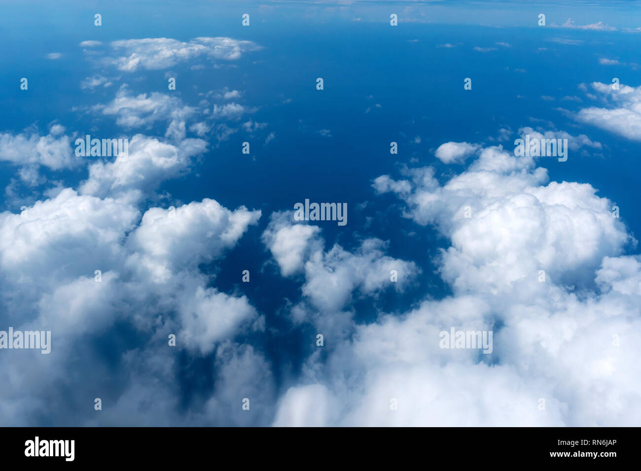Beautiful blue sky with white clouds outer view from flight of air height space. Stock Photo