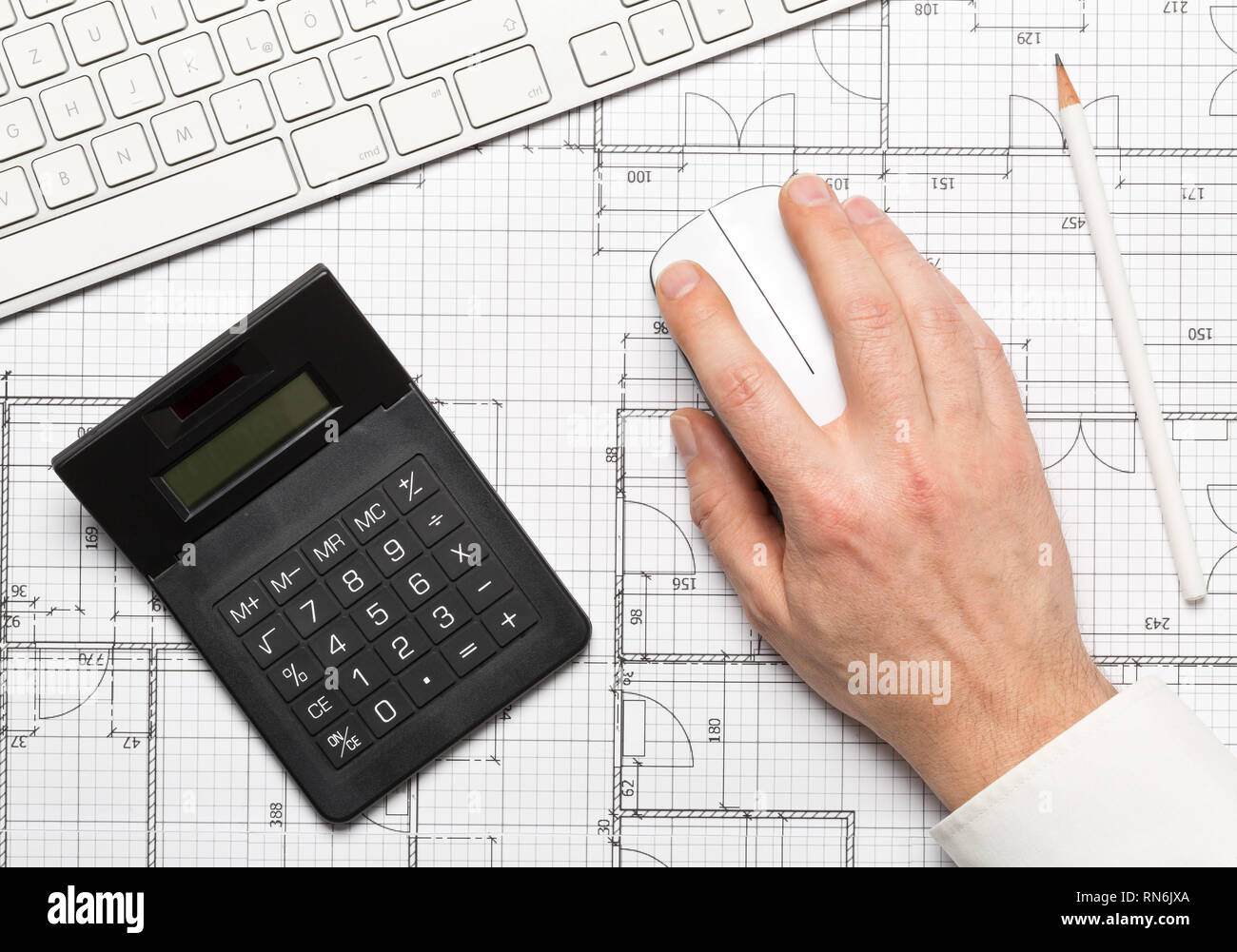 Architect using computer mouse on architectural blueprint house