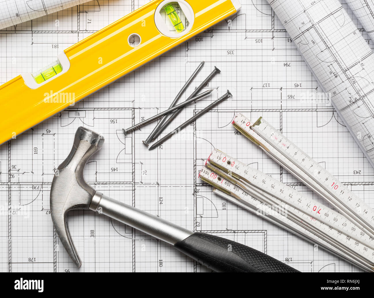 Construction tools with hammer, nails, folding rule and level on