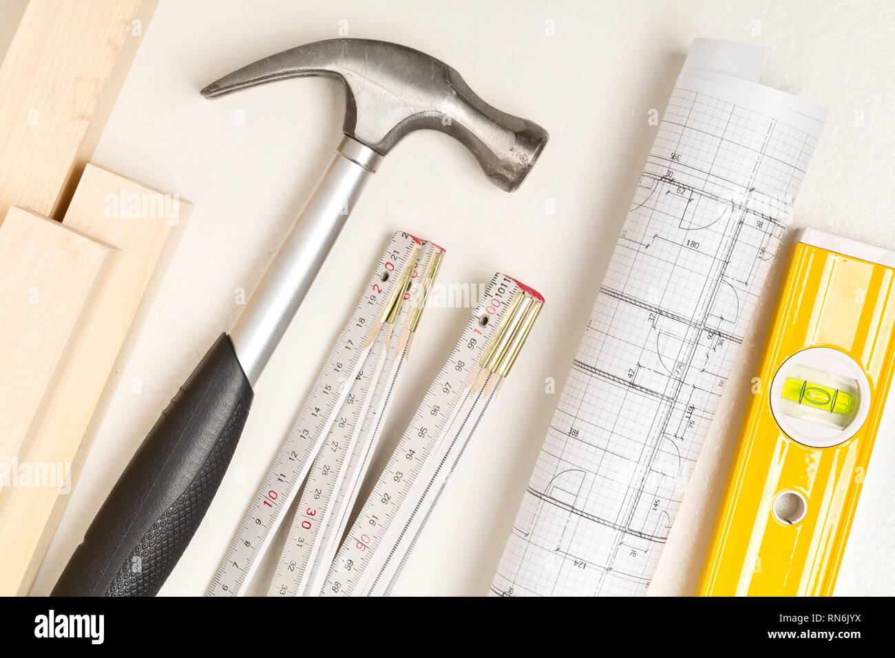 Construction tools, architectural blueprint and wooden strips on white ...