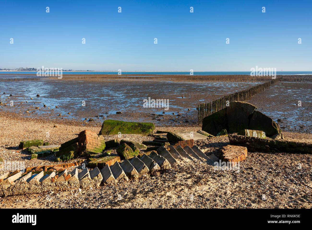 World War Two Pillbox or gun emplacement, fallen into the sea due to coastal erosion. Cudmore Grove Country Park, East Mersea, Essex. Stock Photo