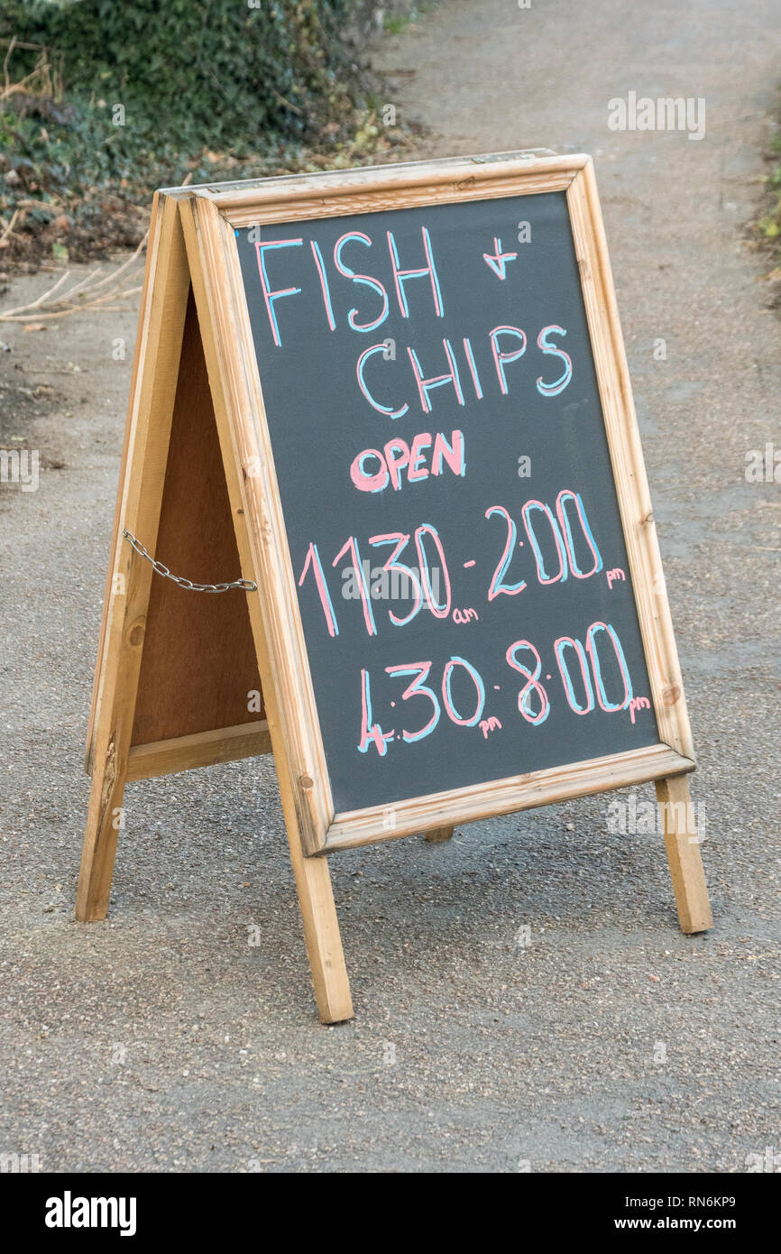 Opening hours A-Frame sign outside a Fish and Chip shop in Cornwall. Stock Photo