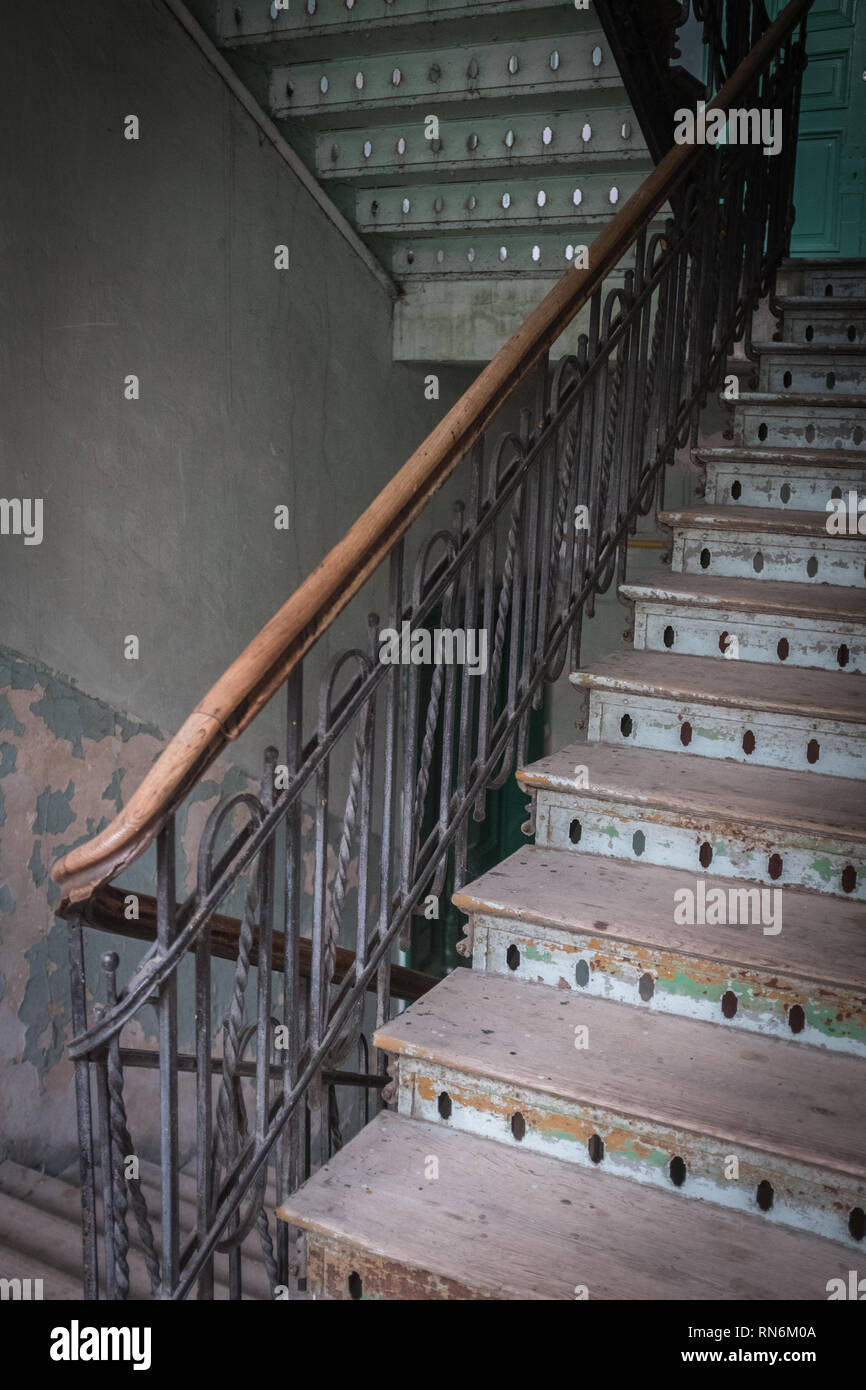 wooden staircase in daylight with worn treads in a tenement house Stock Photo