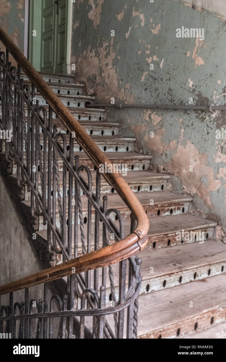 old wooden staircase leading to a room in a tenement block Stock Photo
