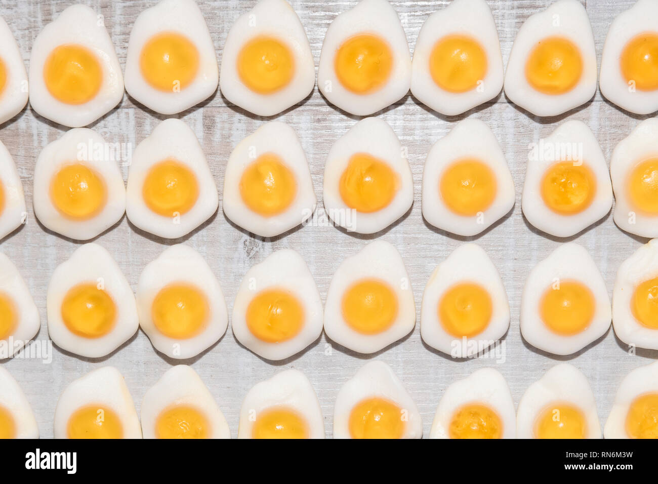 candy fried eggs shaped on a light wooden background Stock Photo