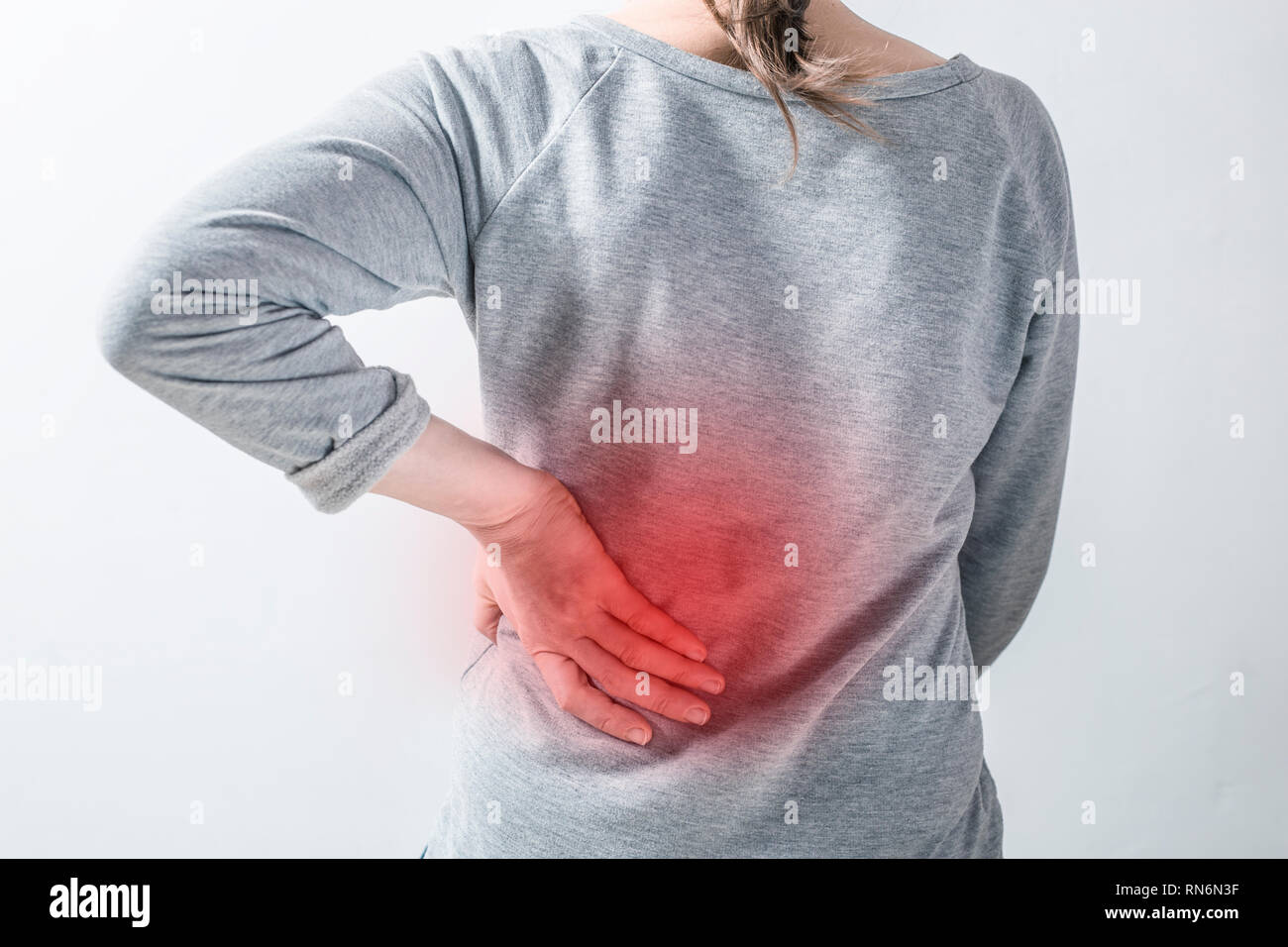 Pain in the kidneys. Women holding their hands behind their backs Stock