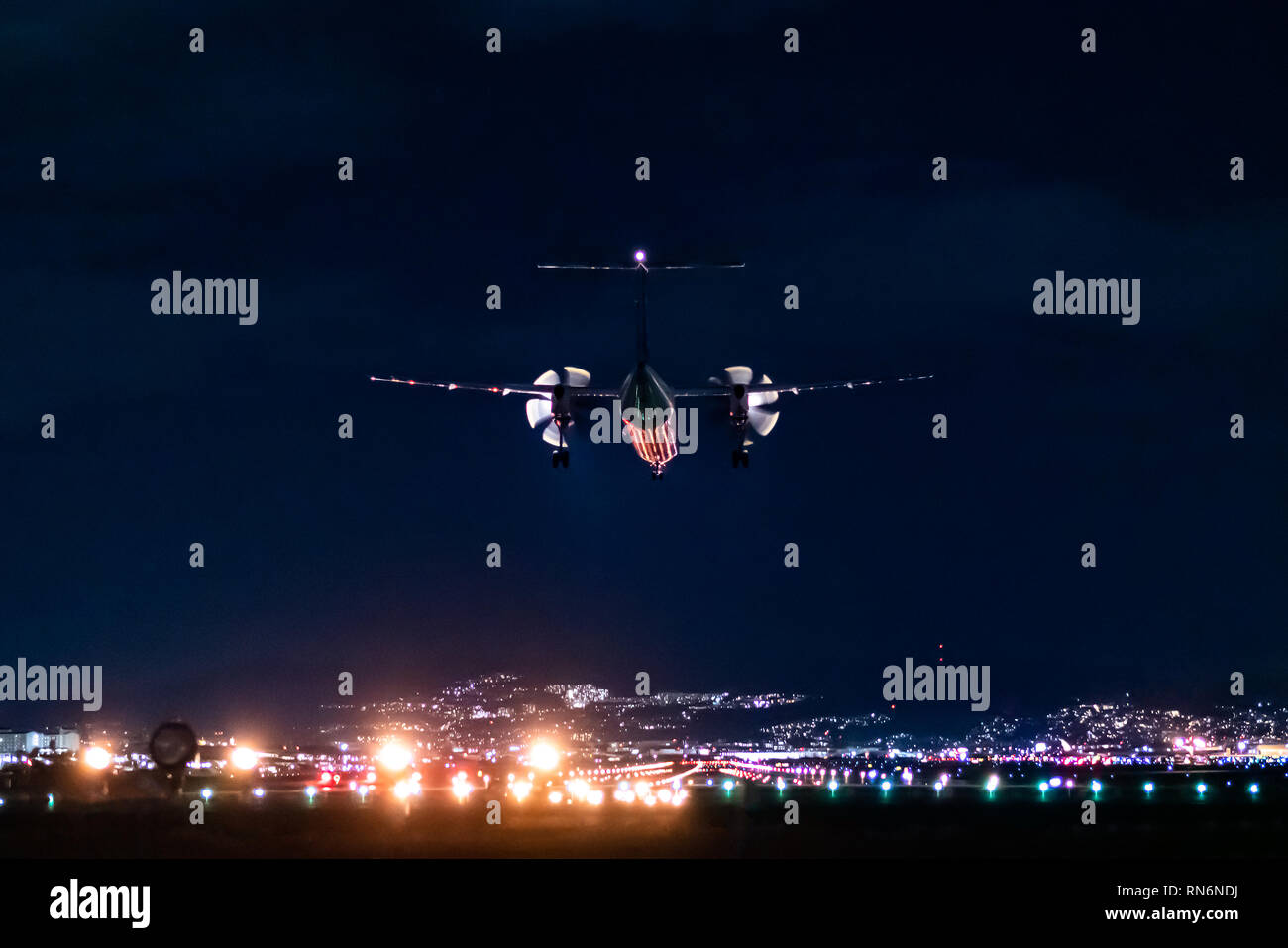 Propeller plane landing scene in the night Stock Photo Alamy