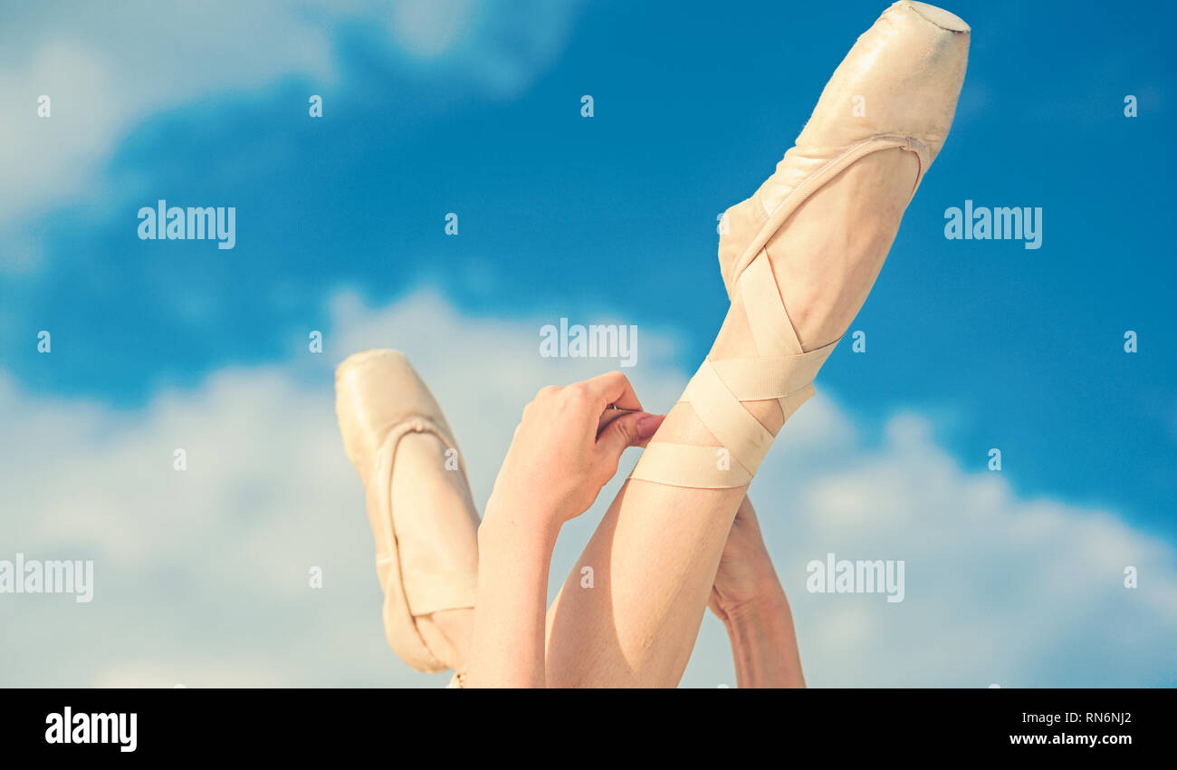 Accentuating the beauty. Ballet slippers. Ballerina shoes. Ballerina legs in ballet shoes. Feet in pointe shoes. Pointe shoes worn by ballet dancer Stock Photo