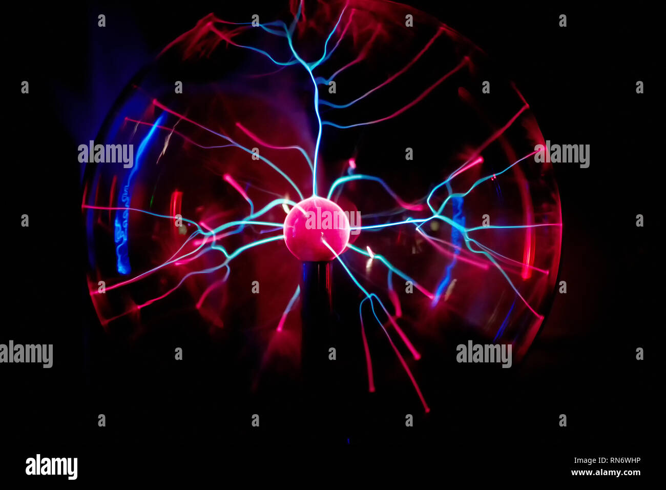 Electric plasma ball on dark background. Static electricity model Stock