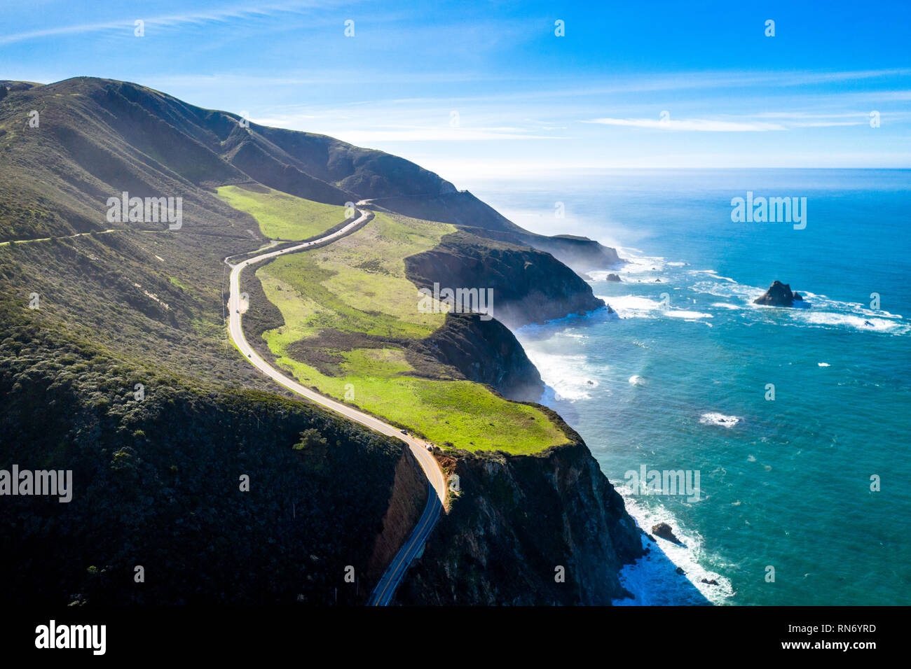 Aerial View Drone Shot of Highway Pacific Coast Highway California USA Big Sur Mountains Ocean Fog Stock Photo