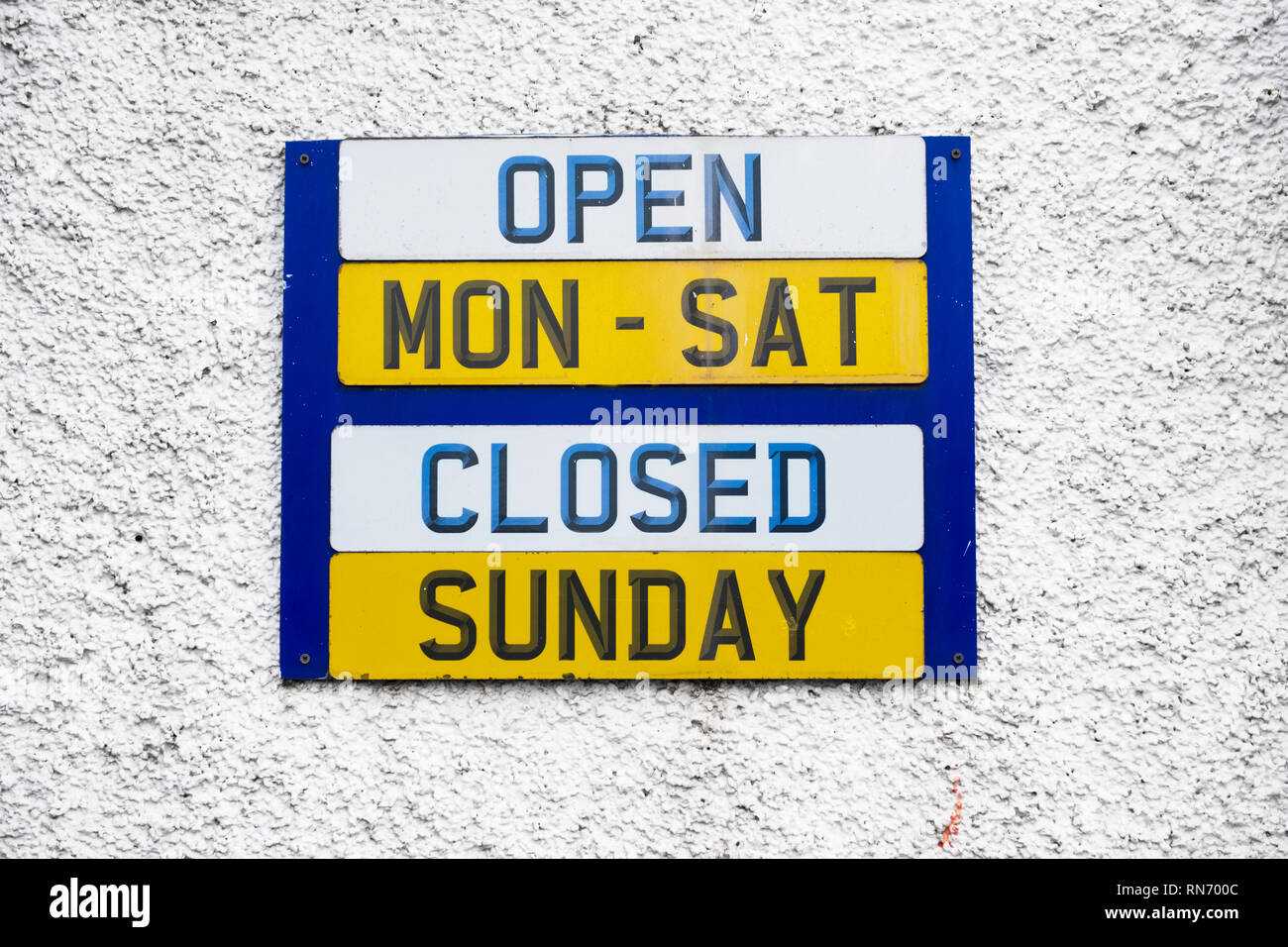 Opening hours shop sign Monday to Friday daytime closed Sunday Stock