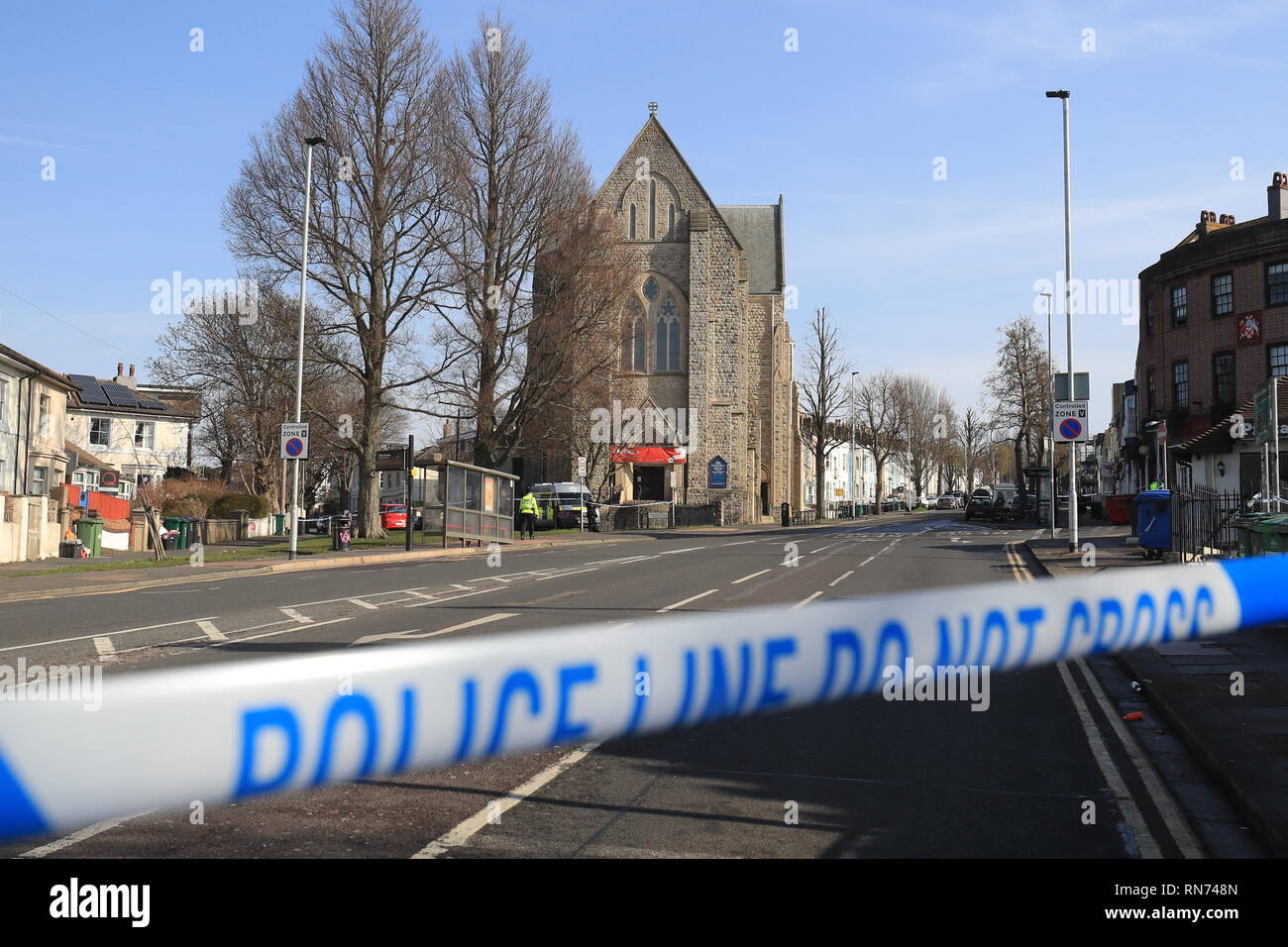 Police tape at a crime scene near St Joseph's Church in Brighton. The brother of two British teenagers killed fighting for Islamists in Syria has died in hospital after being stabbed in a car after it crashed in the city, police said. Stock Photo