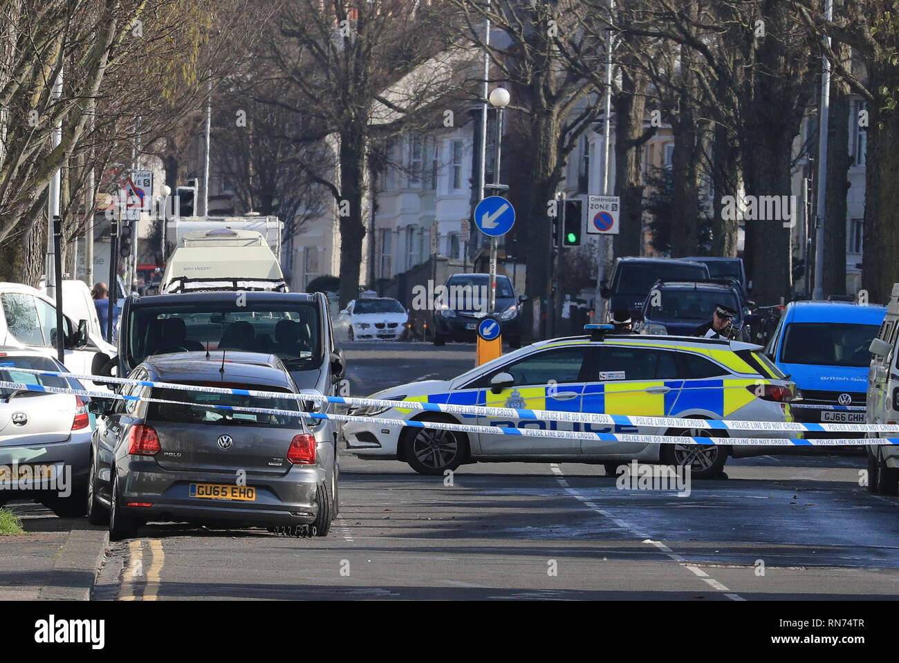 Police tape surrounds a silver Volkswagen Polo (left) where Abdul Deghayes was found injured in the passenger seat, near St Joseph's Church in Brighton. The brother of two British teenagers killed fighting for Islamists in Syria has died in hospital after being stabbed in a car after it crashed in the city, police said. Stock Photo