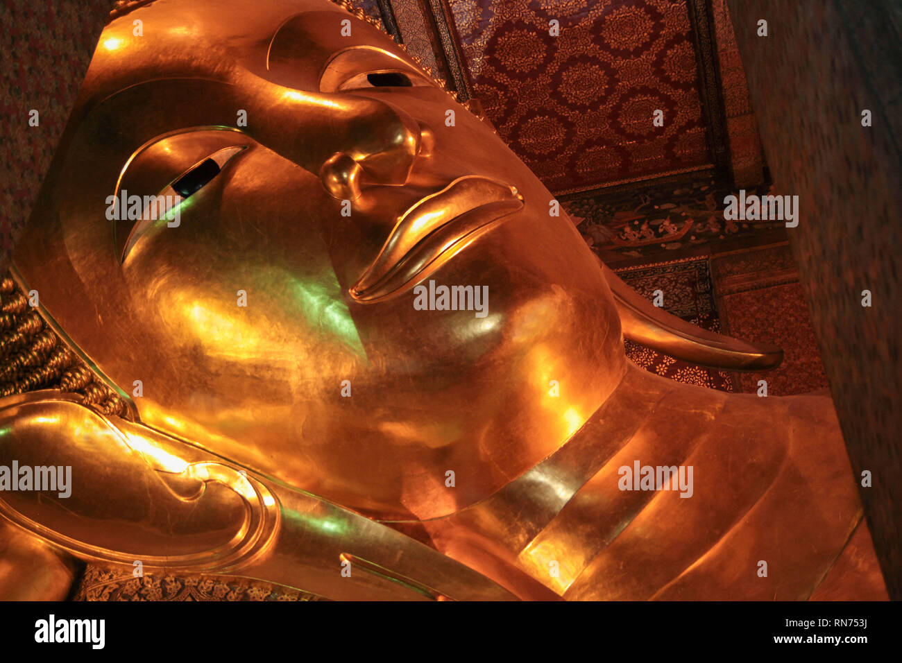 Reclining Buddha gold statue face in Wat Pho, Bangkok Stock Photo