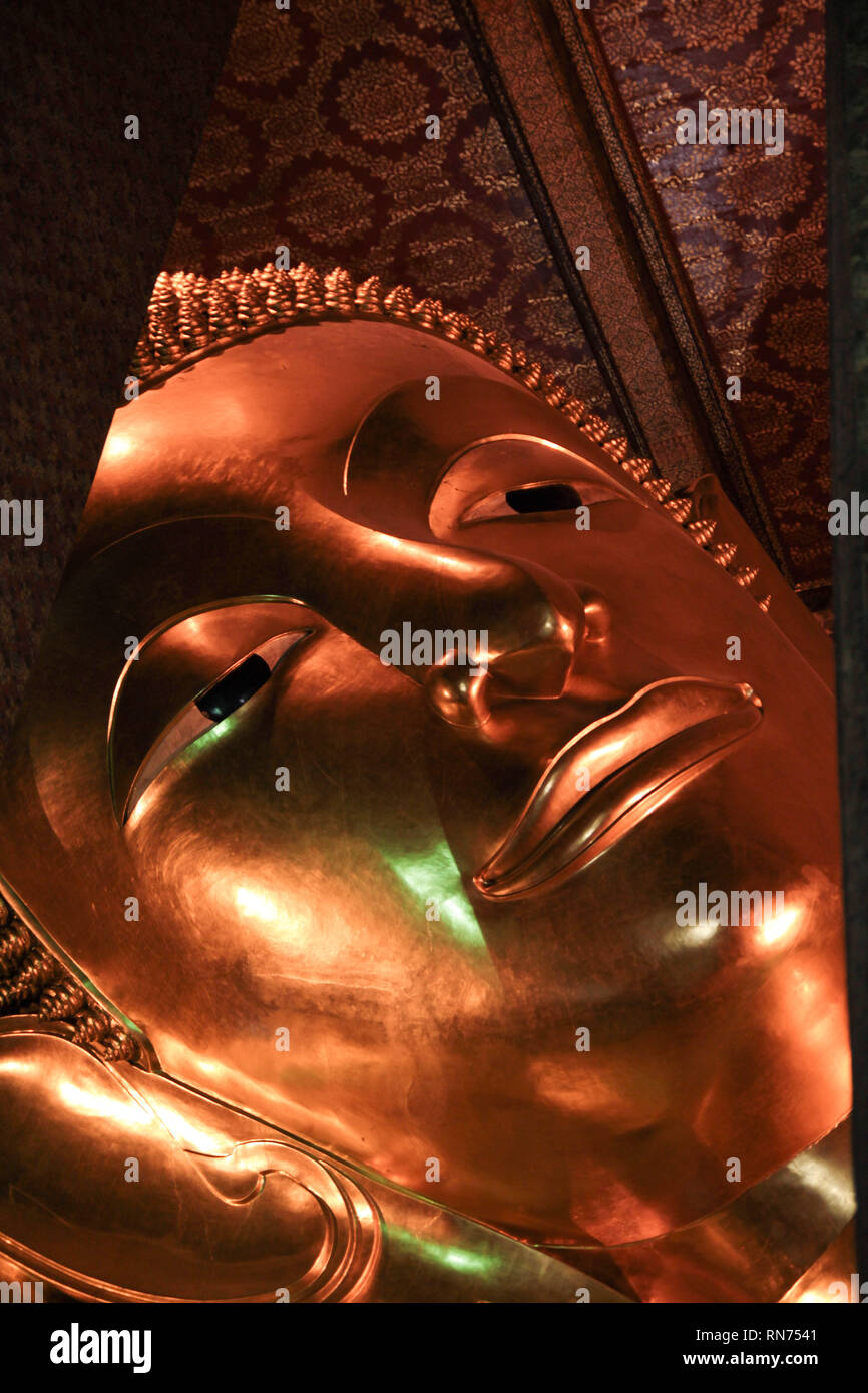 Reclining Buddha gold statue face in Wat Pho, Bangkok Stock Photo