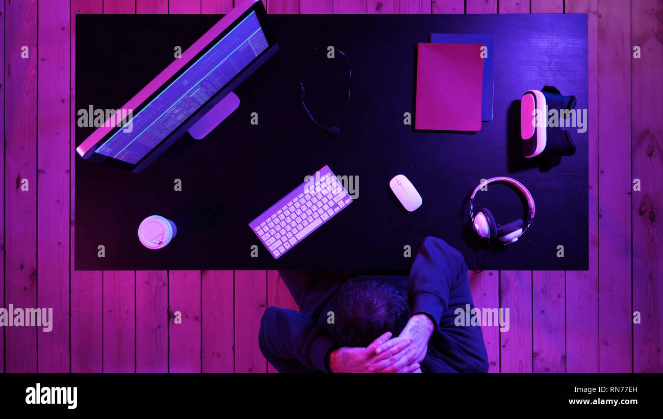 A programmer working on his computer having pain in his neck. Stock Photo