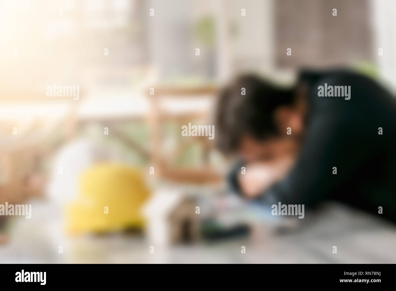Blurred Businessman Engineer a sleep at office desk with document and worksheet ,concept for overworked Stock Photo