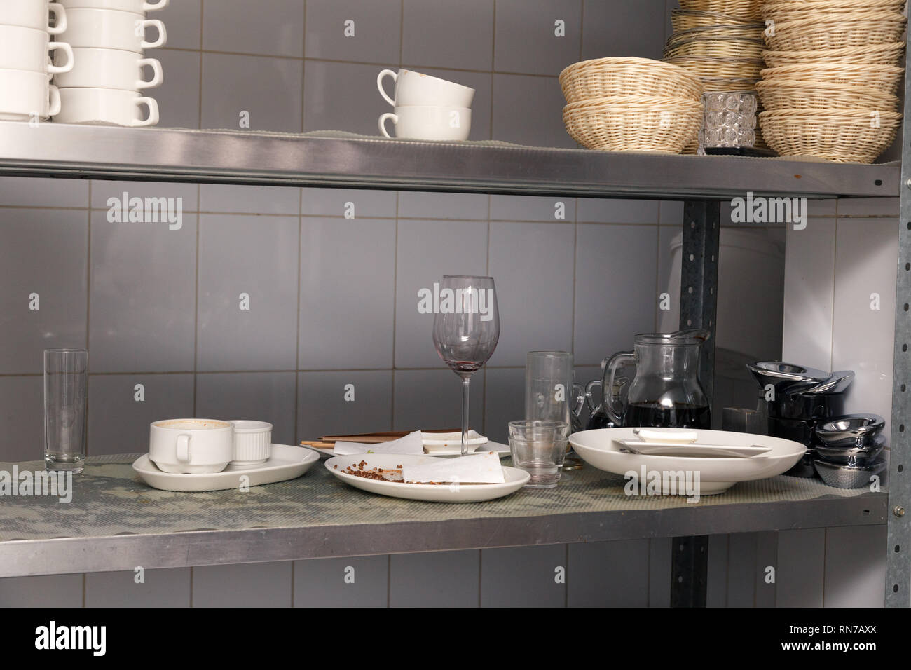 Dirty Dishes Wine Glasses Plates Cups On A Metal Rack In The