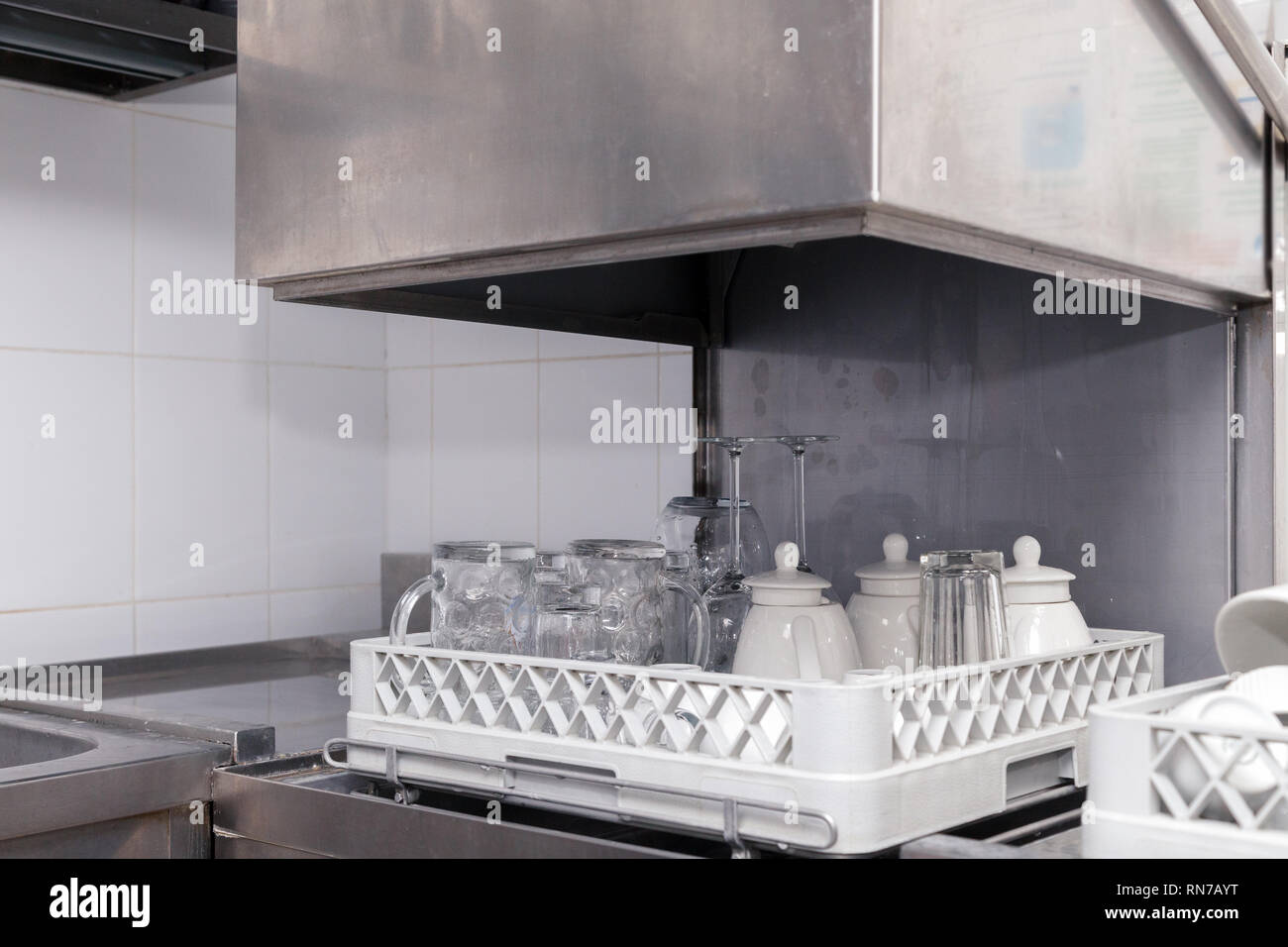 Clean utensils in the dishwasher in restaurant. Wine glasses, beer mugs