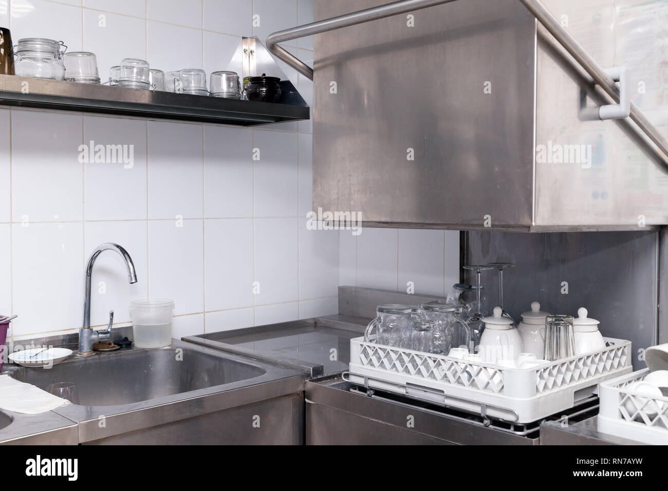 Clean utensils in the dishwasher in restaurant. Wine glasses, beer mugs