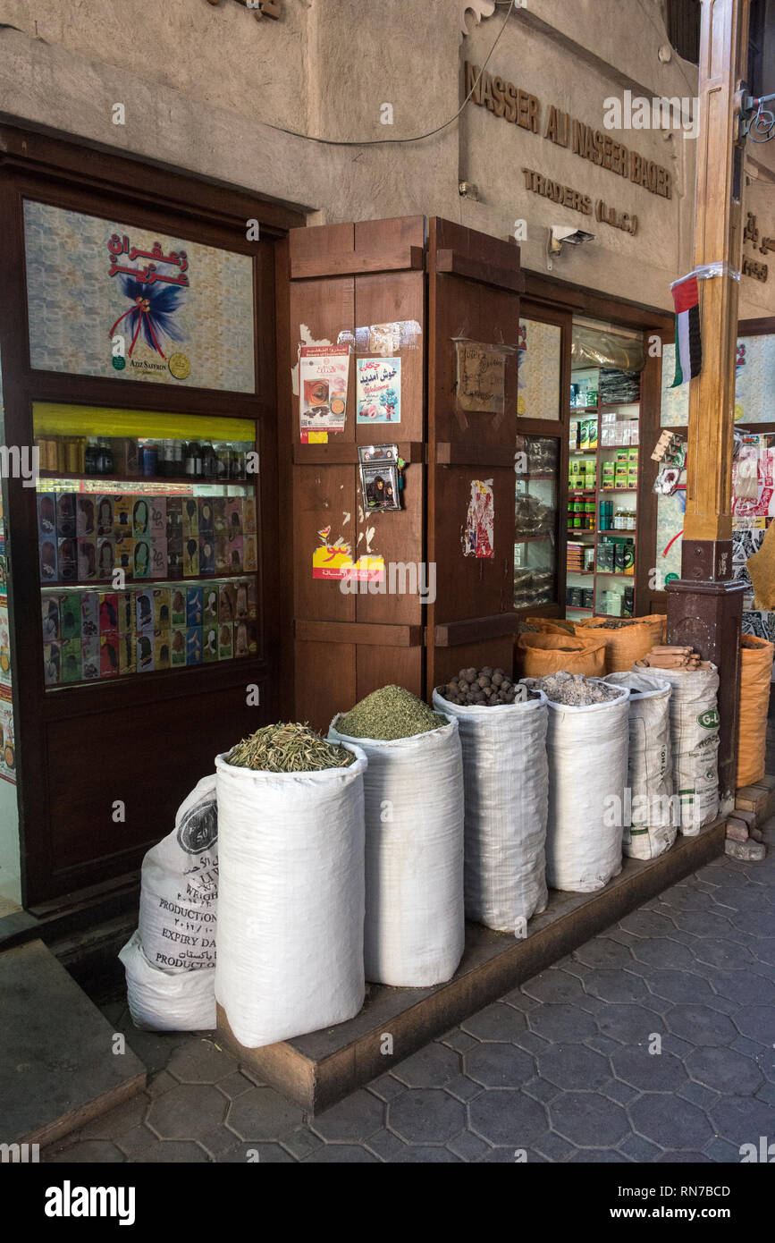 Sacks of dried scented flower petals,  Arabian spices, fresh nutmegs and other spices on sale in the Old Spice Souk in Deira in Dubai in the United Ar Stock Photo