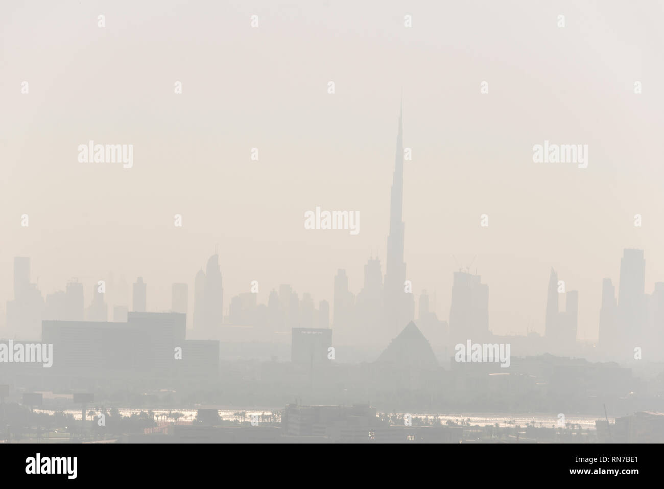 Late afternoon of a thick heat haze over Downtown Dubai and the 629.8m tall  Burj Khalifa, known as Burj Dubai in Dubai, UAE. in the United Arab Emira Stock Photo