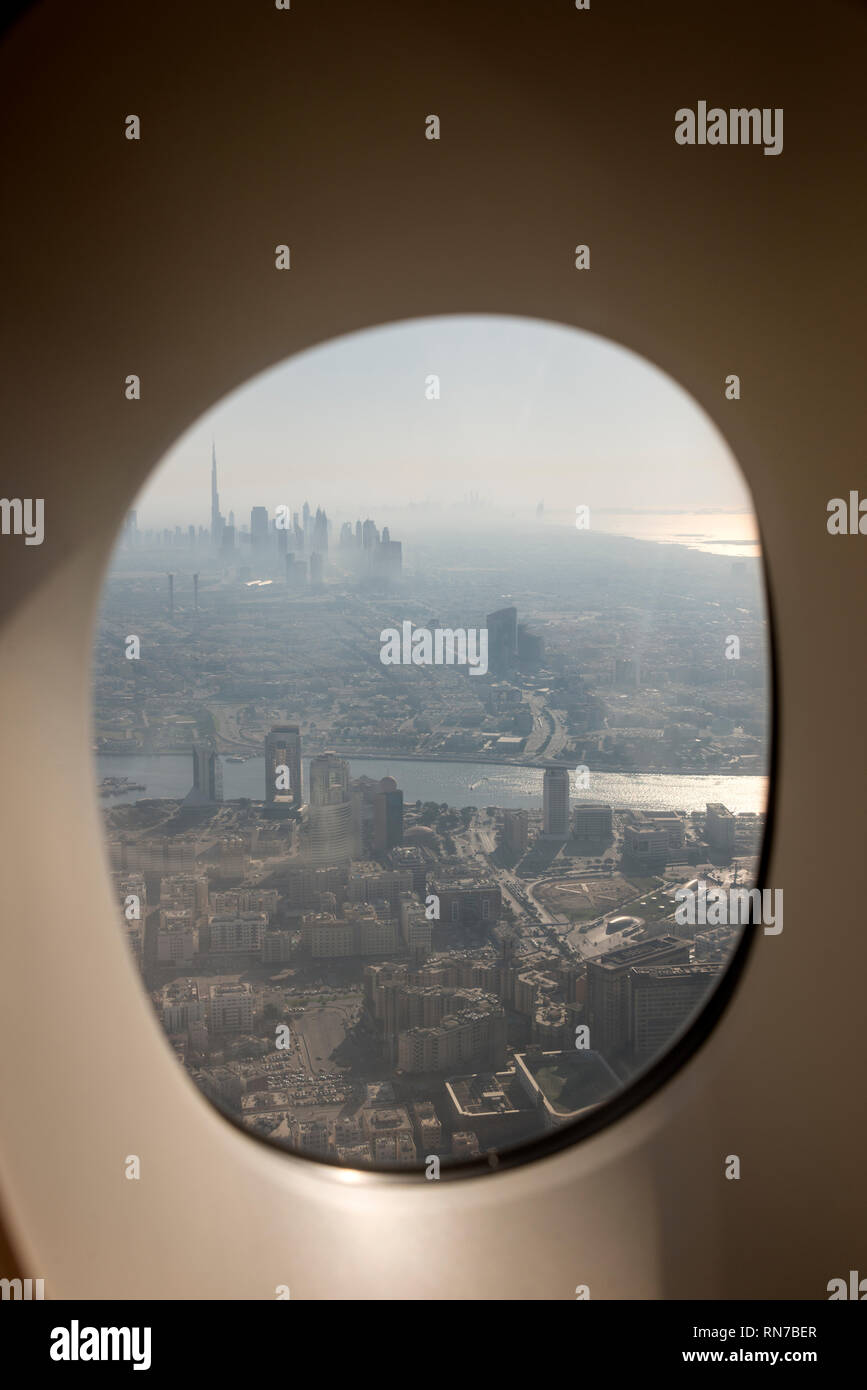 An aircraft window view of a late afternoon of a thick heat haze 
