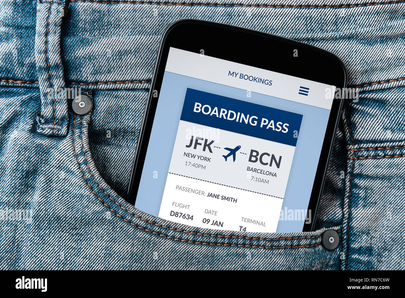 Boarding pass concept on smartphone screen in jeans pocket. All screen content is designed by me. Flat lay Stock Photo
