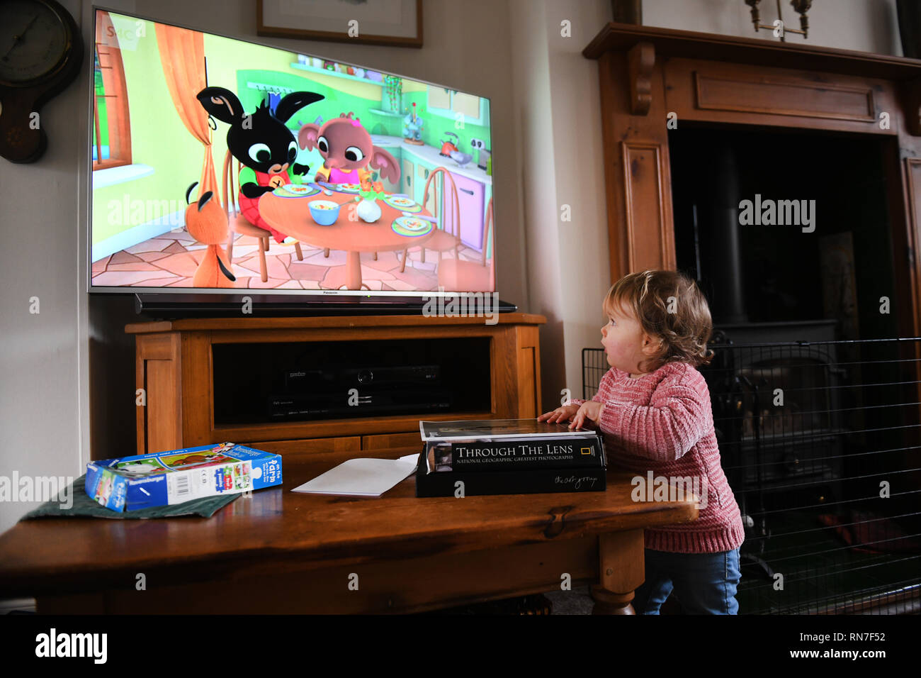 Child watching childrens TV television programme Stock Photo