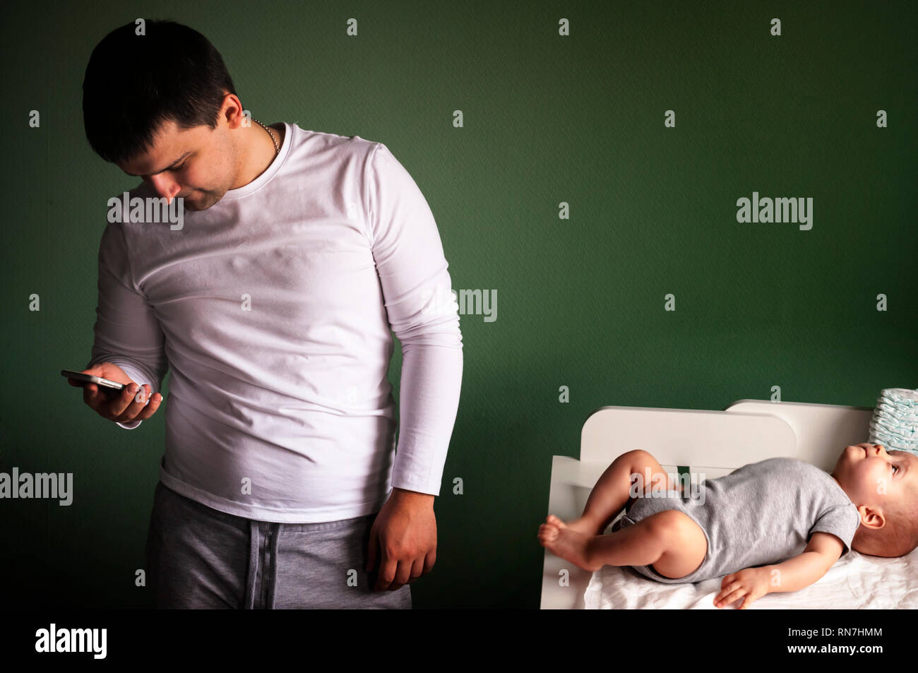 Dad was distracted by a mobile phone from children lying on the