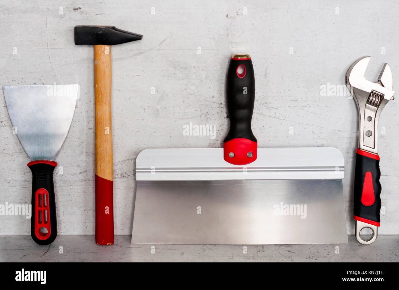 Construction tools are located on a light concrete background Stock Photo