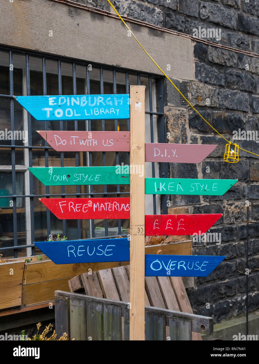 Quirky joke wooden signpost, Edinburgh tool library, Lieth Custom House, Edinburgh, Scotland, UK Stock Photo