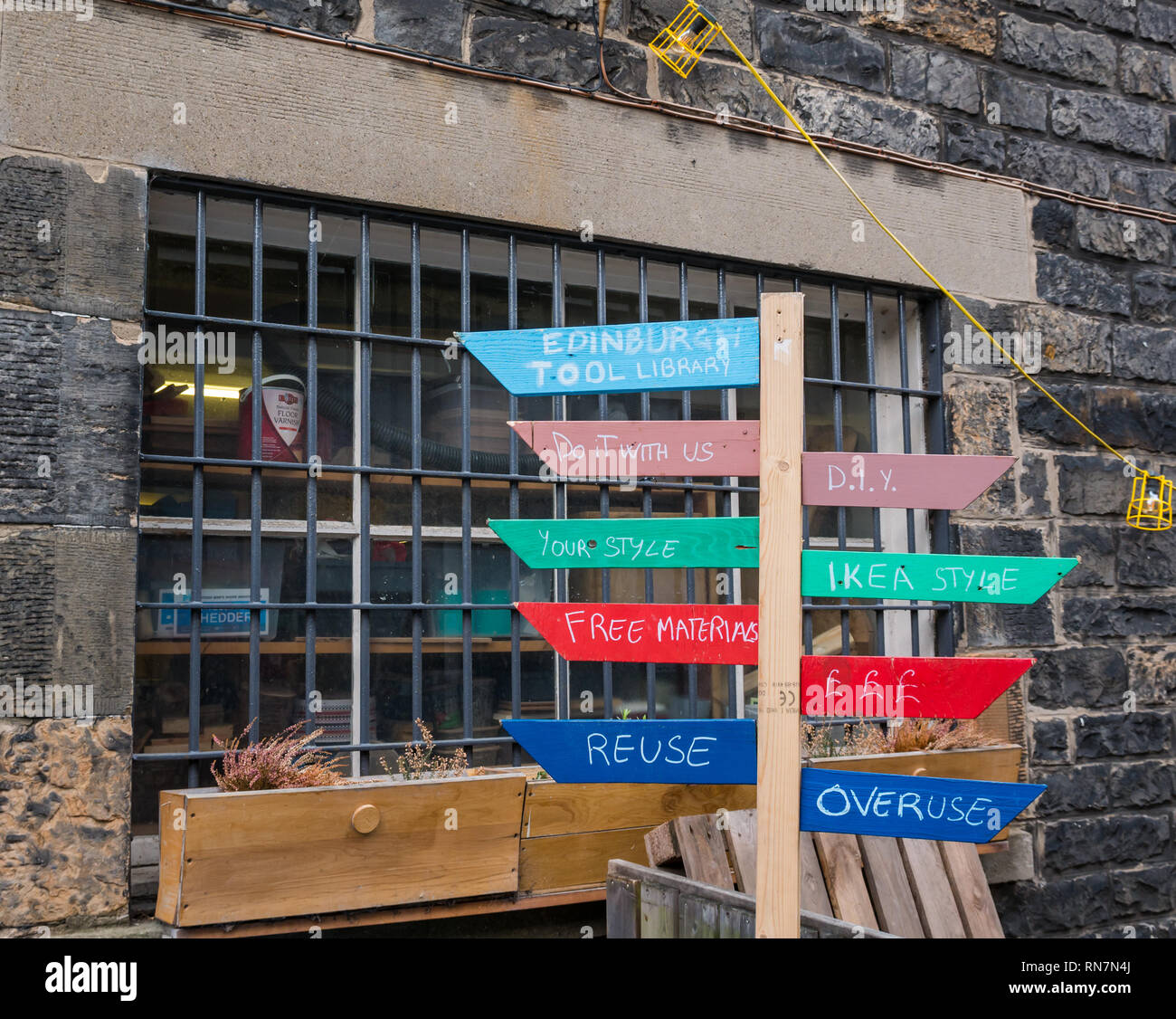 Quirky joke wooden signpost, Edinburgh tool library, Lieth Custom House, Edinburgh, Scotland, UK Stock Photo