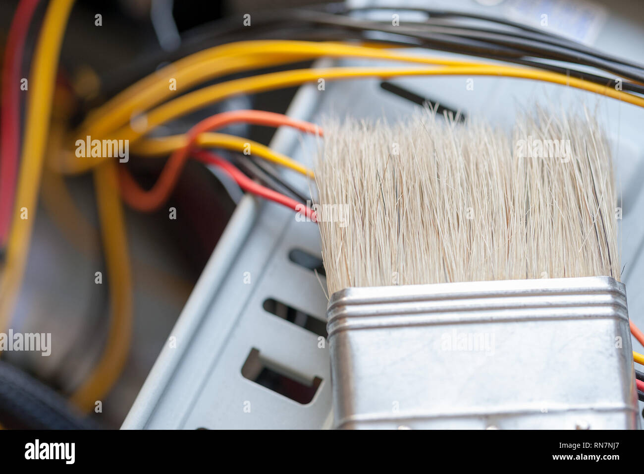 desktop computer dust cleaning with tassel. computer power wires Stock