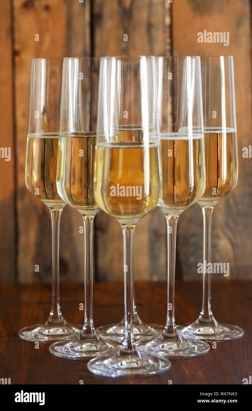 Glasses of champagne on blurred wooden background Stock Photo