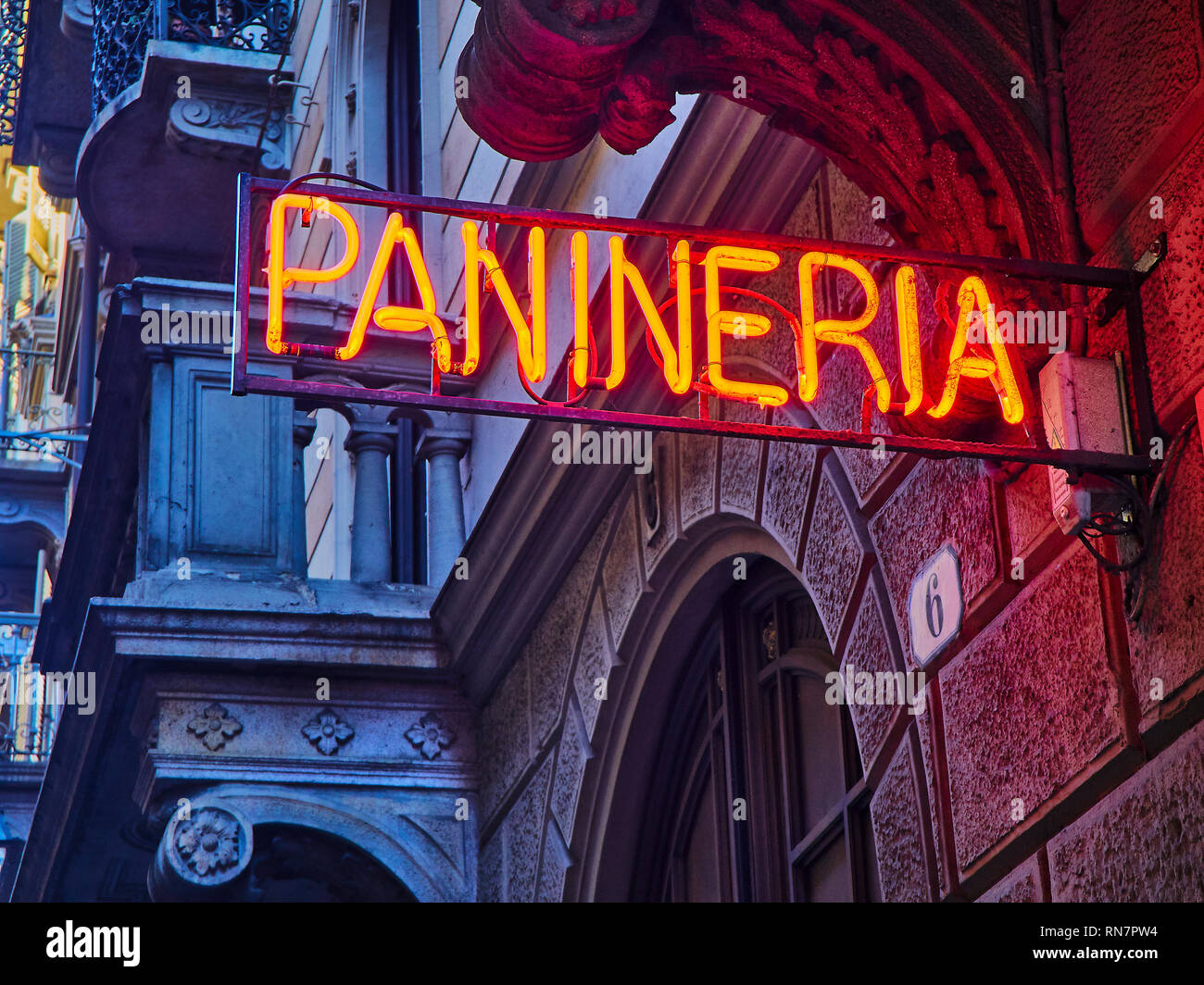 Panineria Neon signboard in an Italian street at nightfall. Stock Photo