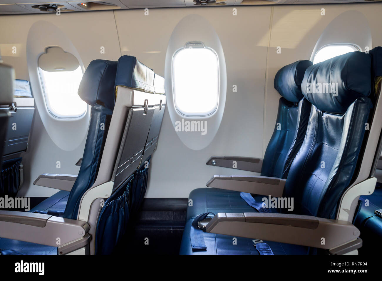 Interior passenger airliner cabin, of the aircraft during the flight of tourists flying into a airplane inside interior Stock Photo