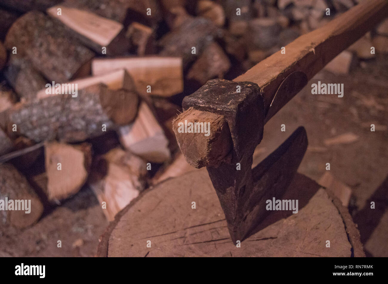 Axe and fire wood in basement Stock Photo