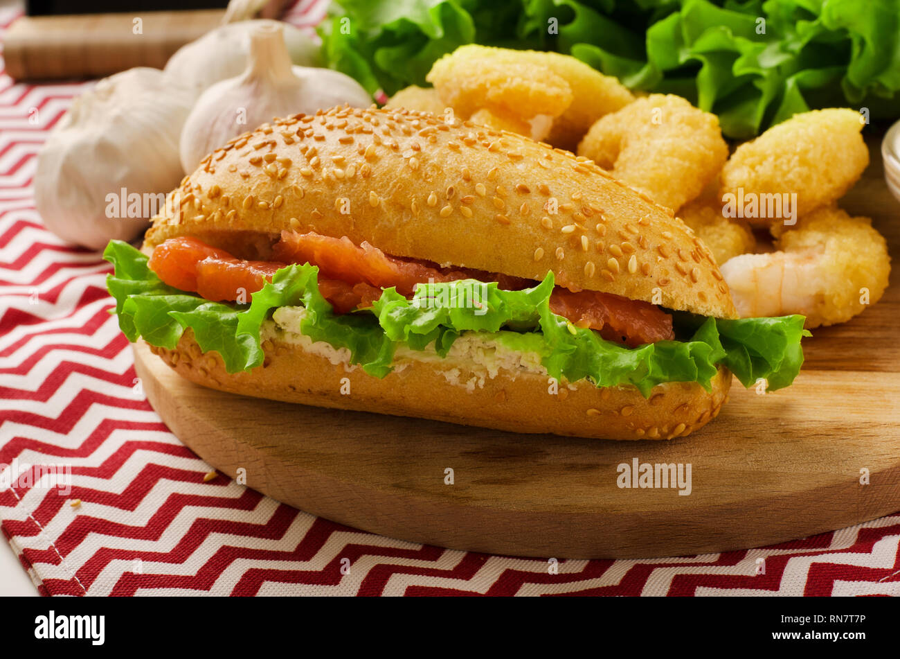 Open sandwich with cream cheese, salmon and salad on a cutting board Stock Photo
