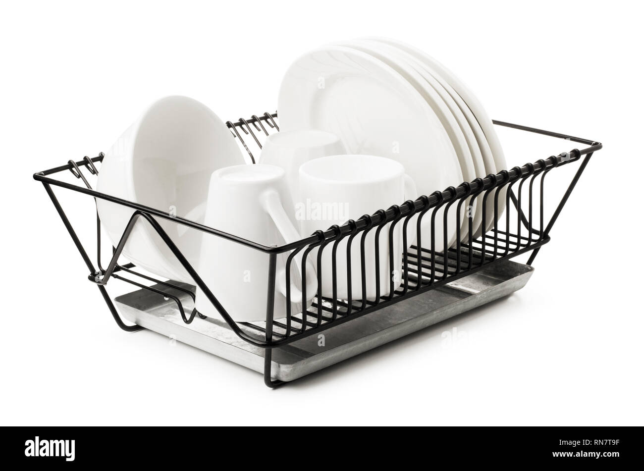 Clean dishes drying on metal dish rack, isolated on white background Stock Photo