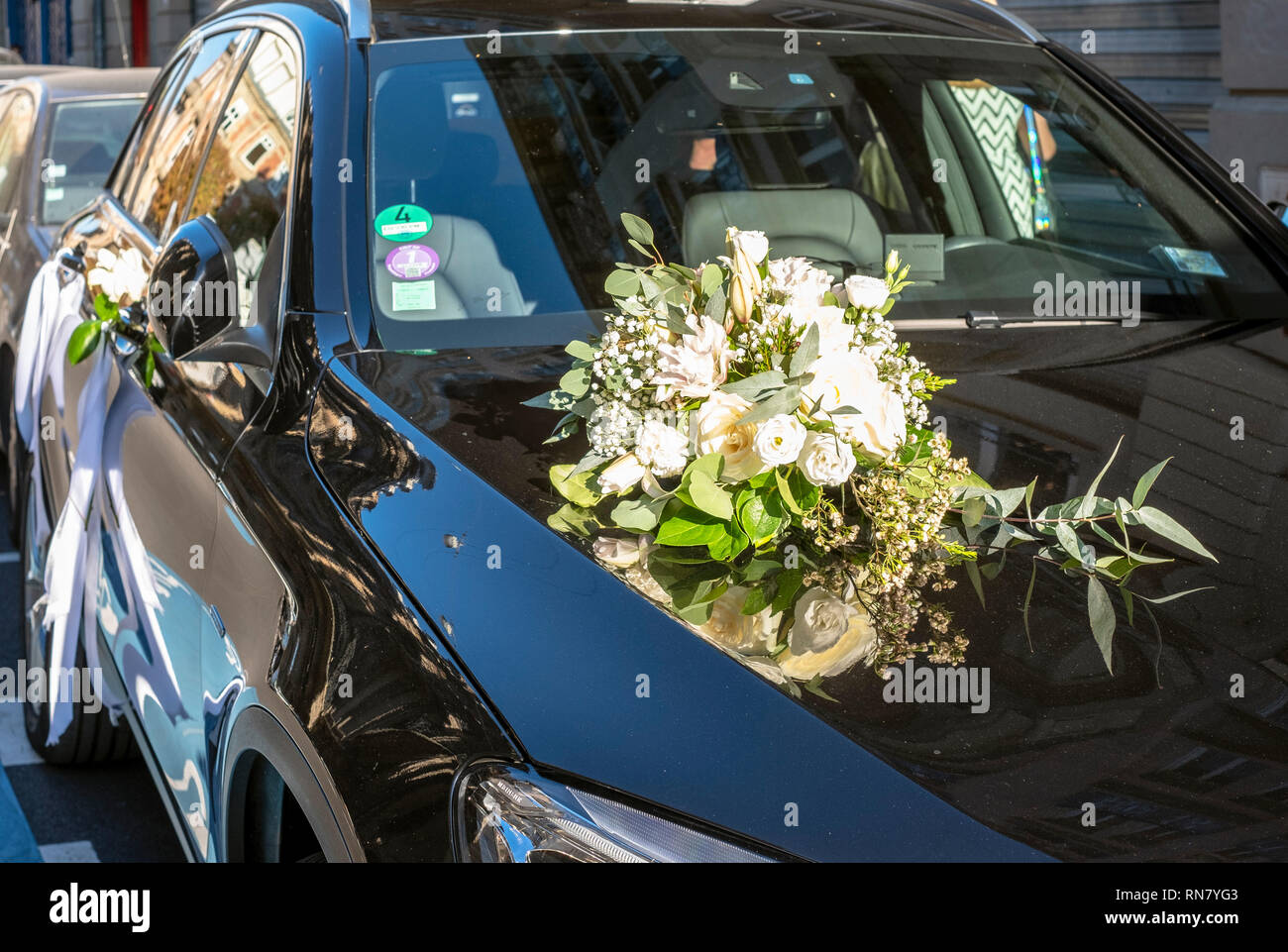 France, wedding bouquet with white flowers on the bonnet of a black car, Stock Photo