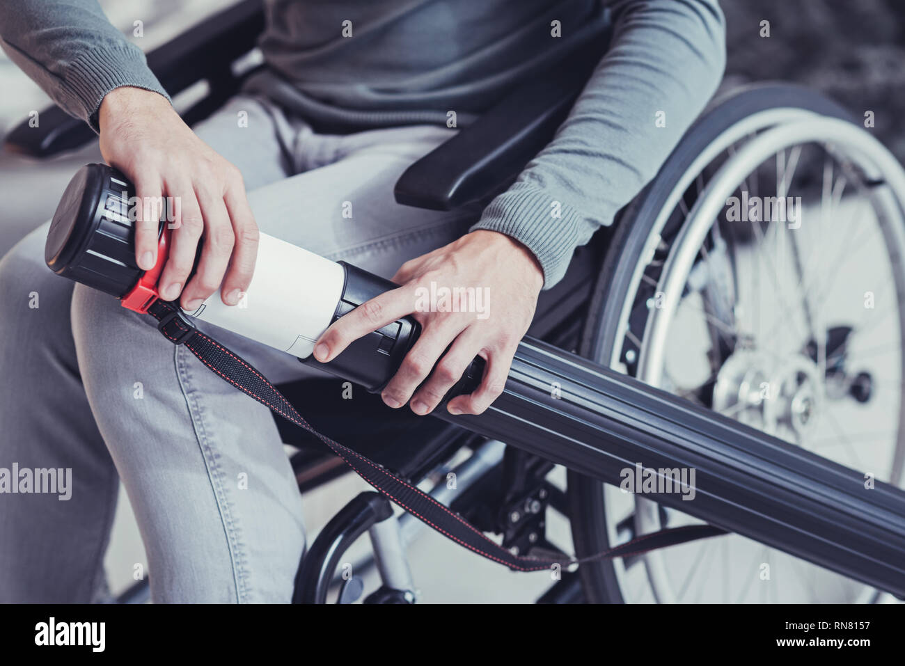 Technical drawing. Close up of a technical blueprint being in the tube in the hands of a smart disabled engineer Stock Photo