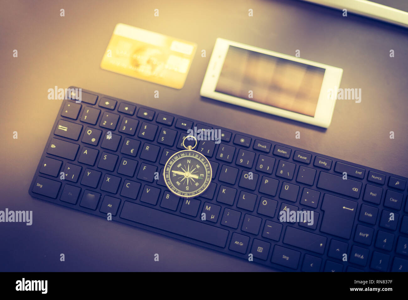 Web business: Arrangement of keyboard, compass, credit card and smartphone Stock Photo