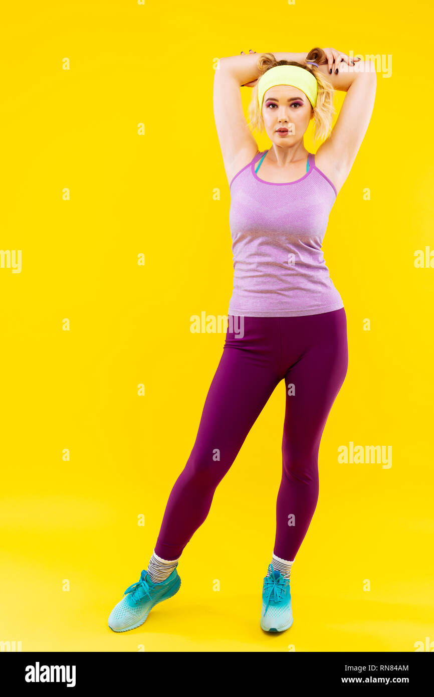 Woman wearing bright purple leggings showing her back Stock Photo - Alamy