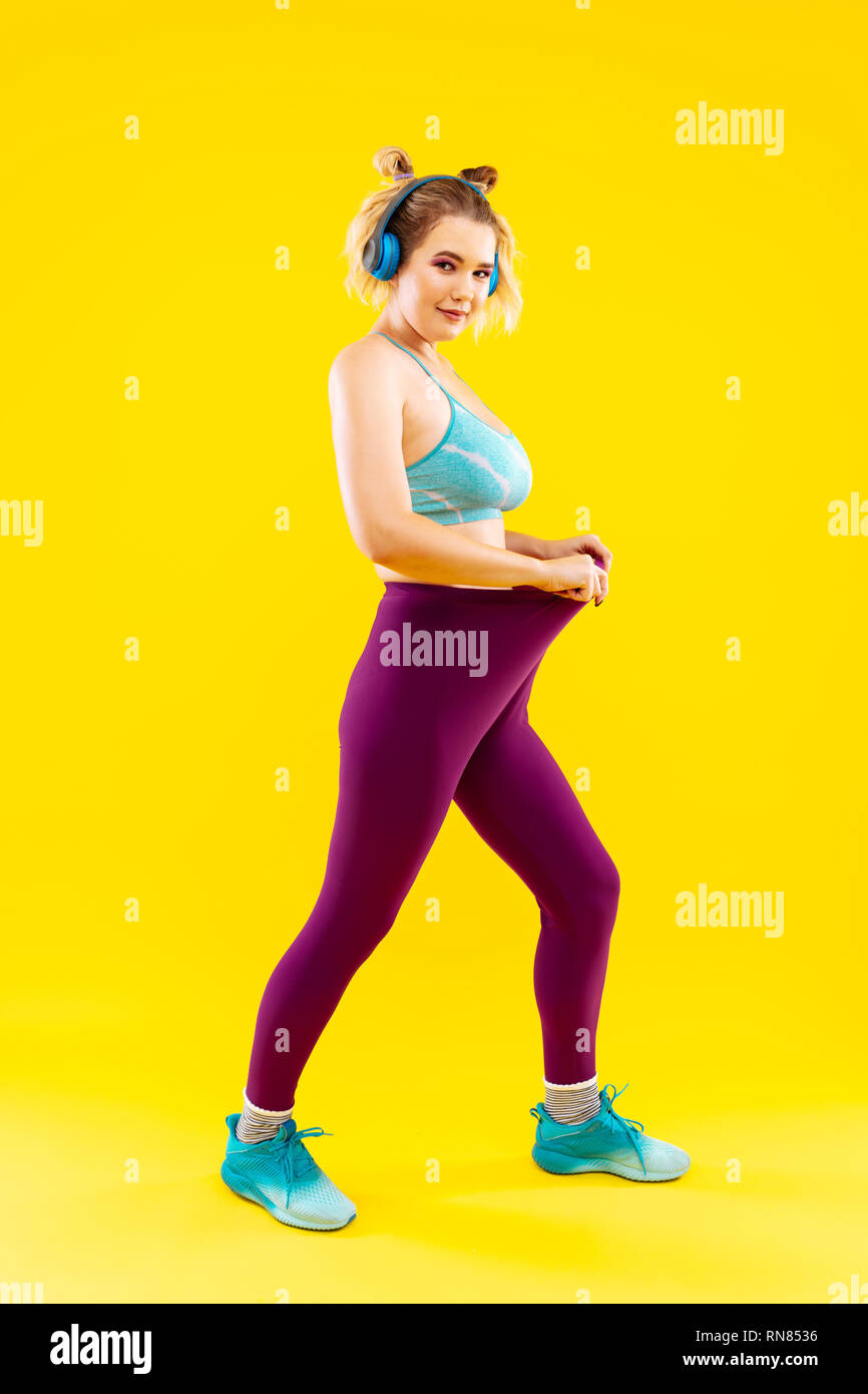 Woman wearing purple leggings showing her amazing result Stock Photo