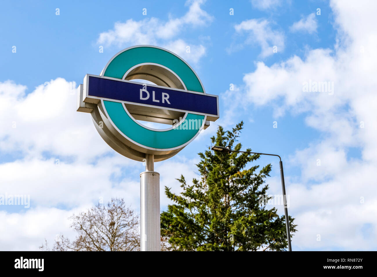 LONDON. ENGLAND - March 20 2018: DLR Sign, Docklands Light Railway, automated system, opened in 1987, serving Docklands area, on a sunny day. Stock Photo