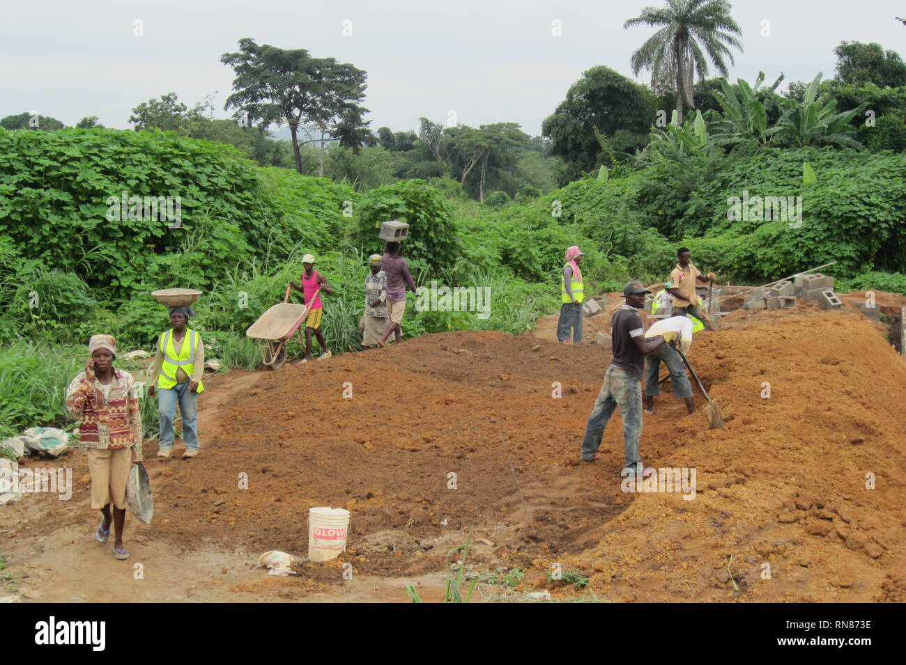 Nigerian man and women working in the construction site, making manual earth movement Stock Photo